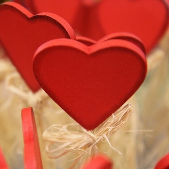 Playing proactive versus playing hard to get... Photo of hearts on sticks