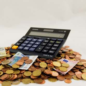 Calculator sitting on a pile of money