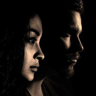 Husband and wife standing side by side in relief
